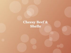 A food title card for 'Cheesy Beef & Shells' displayed against a warm, peachy bokeh background with soft circular light effects.